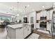 Modern kitchen with stainless steel appliances, granite countertops, and island seating at 19370 Hawk Valley Dr, Tampa, FL 33647