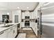 Bright kitchen featuring white cabinets, stainless appliances, and granite countertops at 19370 Hawk Valley Dr, Tampa, FL 33647