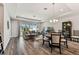 Open living and dining area with hardwood floors and sliding glass doors to the backyard at 19370 Hawk Valley Dr, Tampa, FL 33647