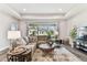 Bright living room featuring a large window, a comfortable sectional sofa, and stylish decor at 19370 Hawk Valley Dr, Tampa, FL 33647