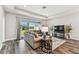 Comfortable living room with hardwood floors, recessed lighting and sliding door to the backyard at 19370 Hawk Valley Dr, Tampa, FL 33647