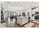 Open-concept living area featuring kitchen, dining, and living spaces with sliding glass doors at 19370 Hawk Valley Dr, Tampa, FL 33647