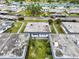 Expansive aerial view of a community showcasing well-maintained lawns, mature trees, and convenient carport parking at 205 Andover N Pl # 110, Sun City Center, FL 33573
