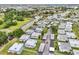 Gorgeous aerial shot of a community with a serene pond, lush landscaping, and well-maintained carports at 205 Andover N Pl # 110, Sun City Center, FL 33573