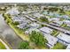 Stunning aerial view of a thriving community with well-kept lawns, mature trees, and beautiful water features at 205 Andover N Pl # 110, Sun City Center, FL 33573