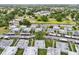 An aerial view showcasing the community, featuring well-maintained lawns, covered parking, and nearby green spaces at 205 Andover N Pl # 110, Sun City Center, FL 33573