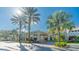 Inviting clubhouse entrance with lush landscaping and covered portico at 205 Andover N Pl # 110, Sun City Center, FL 33573