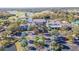 Beautiful aerial view of the community clubhouse, golf course, and surrounding greenery at 205 Andover N Pl # 110, Sun City Center, FL 33573