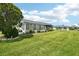 Charming home exterior features a screened lanai and well-maintained lawn in a serene community at 205 Andover N Pl # 110, Sun City Center, FL 33573