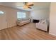 Inviting living room featuring wood-look floors and sun-filled windows at 205 Andover N Pl # 110, Sun City Center, FL 33573