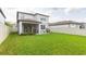 Expansive backyard features a screened-in porch and well-maintained lawn, ideal for outdoor activities at 20925 Monza Loop, Land O Lakes, FL 34638