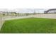 Spacious backyard with lush green grass, and views of the pond at 20925 Monza Loop, Land O Lakes, FL 34638