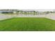 Spacious backyard with lush green grass, and views of the pond at 20925 Monza Loop, Land O Lakes, FL 34638