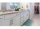Well-lit bathroom featuring granite countertop, double vanity, and walk-in closet at 20925 Monza Loop, Land O Lakes, FL 34638