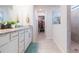 Clean bathroom with double vanity, granite countertop, and walk-in closet access at 20925 Monza Loop, Land O Lakes, FL 34638