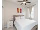 Well-lit bedroom features a large bed, nightstand, and window with curtains, creating a cozy atmosphere at 20925 Monza Loop, Land O Lakes, FL 34638