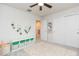 Bright bedroom with a ceiling fan, plush rug, and a storage cabinet at 20925 Monza Loop, Land O Lakes, FL 34638