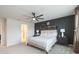 Serene bedroom with dark accent wall, decorative shelves, and ceiling fan at 20925 Monza Loop, Land O Lakes, FL 34638