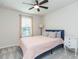 Charming bedroom with a comfy bed, a window view, and a decorative side table at 20925 Monza Loop, Land O Lakes, FL 34638