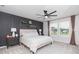 Relaxing bedroom with decorative shelves, neutral walls, and large windows at 20925 Monza Loop, Land O Lakes, FL 34638