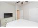 Bright bedroom with ceiling fan, television on dresser and window with curtain at 20925 Monza Loop, Land O Lakes, FL 34638