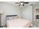 Cozy bedroom features a ceiling fan, neutral walls, and soft carpet flooring at 20925 Monza Loop, Land O Lakes, FL 34638