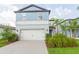 Charming two-story home features a well-manicured lawn and two car garage at 20925 Monza Loop, Land O Lakes, FL 34638