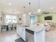 Modern kitchen features an island with bar seating, granite countertops, and stainless steel appliances at 20925 Monza Loop, Land O Lakes, FL 34638