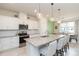 Bright kitchen with granite countertops, stainless steel appliances, and an island with bar stools at 20925 Monza Loop, Land O Lakes, FL 34638