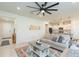 Spacious living room with open floor plan to kitchen and large ceiling fan at 20925 Monza Loop, Land O Lakes, FL 34638