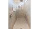 Modern walk-in shower featuring neutral tile, a built-in niche, and a handheld shower head at 20925 Monza Loop, Land O Lakes, FL 34638