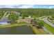 Aerial view highlighting a community with a lake, playground, and wooded areas at 2121 Secret Cv, Odessa, FL 33556