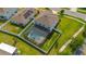 Aerial view of a home with a screened-in pool and patio area surrounded by a white fence and green lawn at 2121 Secret Cv, Odessa, FL 33556