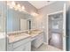 Bright bathroom featuring double sinks, granite countertops, and modern fixtures at 2121 Secret Cv, Odessa, FL 33556