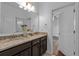This bathroom features a double sink vanity with granite counters and tile floors at 2121 Secret Cv, Odessa, FL 33556