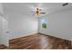 This bedroom features hardwood floors, a window, and a ceiling fan at 2121 Secret Cv, Odessa, FL 33556
