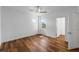 This bedroom features hardwood floors, a ceiling fan, and a window at 2121 Secret Cv, Odessa, FL 33556