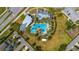 An aerial view shows the community pool and clubhouse surrounded by lounge chairs and palm trees at 2121 Secret Cv, Odessa, FL 33556