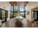 Elegant dining room with floor-to-ceiling windows, a modern chandelier, and ample seating at 2121 Secret Cv, Odessa, FL 33556