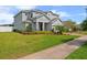 Charming two-story home with a well-manicured lawn and garden, featuring a covered entry way at 2121 Secret Cv, Odessa, FL 33556