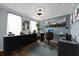 Modern home office with striking decor, contemporary desk, overhead light, and unique wall art at 2121 Secret Cv, Odessa, FL 33556