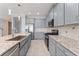 Features a spacious kitchen with gray cabinets, stainless appliances, granite countertops, and a center island at 2121 Secret Cv, Odessa, FL 33556
