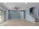 An open living area featuring modern ceiling fan, tile floors, staircase and sliding glass door at 2121 Secret Cv, Odessa, FL 33556
