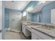 This main bathroom features a glass shower, tile floors, a double sink vanity with granite counters at 2121 Secret Cv, Odessa, FL 33556