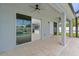 This outdoor covered patio area has a view of the kitchen and pool at 2121 Secret Cv, Odessa, FL 33556