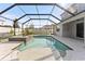 Screened-in pool and spa with tiled deck and fenced yard at 2121 Secret Cv, Odessa, FL 33556