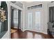 Bright foyer with decorative glass double doors, chandelier, clerestory windows, and hardwood flooring at 21604 Draycott Way, Land O Lakes, FL 34637