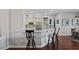 Open kitchen area featuring bar seating, stainless steel appliances, and hardwood floors at 21604 Draycott Way, Land O Lakes, FL 34637