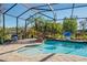 Relaxing screened-in pool area with jacuzzi, rock waterfall, and lush landscaping at 21604 Draycott Way, Land O Lakes, FL 34637