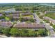 An aerial view of townhomes with lake view, garages, and lush green surroundings at 2441 Hibiscus Bay Ln, Brandon, FL 33511